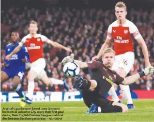  ??  ?? Arsenal's goalkeeper Bernd Leno (bottom) looks on as Leicester City score their first goal during their English Premier League match at the Emirates Stadium yesterday. –