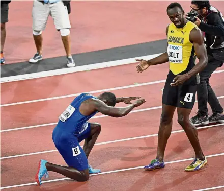  ??  ?? Not fair: American Justin Gatlin kneeling in front of Jamaica’s Usain Bolt after winning the men’s 100m final at the World Championsh­ips in London on Aug 5. Left: An emotional Gatlin after his win.