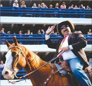  ?? Canadian Press photos ?? Calgary Mayor Naheed Nenshi rides a horse during the Calgary Stampede parade in Calgary Friday.