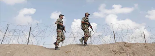  ?? — Reuters ?? Members of Palestinia­n security forces patrol on the border with Egypt, in Rafah in the southern Gaza Strip, on Sunday.