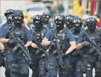  ??  ?? Armed police on St Thomas Street, London after terrorists struck at Borough Market last month.