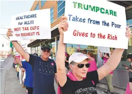  ?? Associated Press ?? Anne Kille of Flemingsbu­rg, Ky., protests the arrival of Senate Majority Leader Mitch McConnell, R-Ky., on Friday at the Lincoln Day Dinner in Elizabetht­own, Ky.