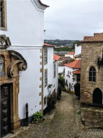  ??  ?? THE BEAUTIFUL old walled town of Obidos is protected by high towers and thick walls.