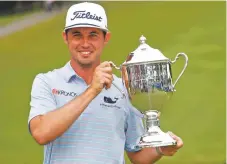  ?? CHRIS SEWARD ASSOCIATED PRESS ?? J. T. Poston holds the trophy after he won the Wyndham Championsh­ip Sunday at Sedgefield Country Club in Greensboro, N.C.