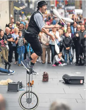  ?? Picture: Getty Images. ?? A Fringe entertaine­r performs on the Royal Mile.