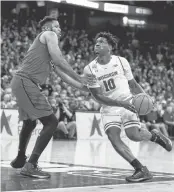  ?? ANDY MANIS/ASSOCIATED PRESS ?? Wisconsin's Nigel Hayes drives against Maryland's Damonte Dodd. Hayes had 14 points in the second half.