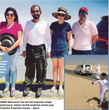  ??  ?? SHEIKH Mohammed (dua dari kiri) bergambar dengan pelancong itu selepas menarik kenderaan mereka yang terkandas di kawasan berpasir. - Agensi