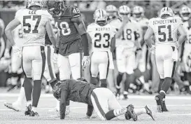  ?? Karen Warren / Houston Chronicle ?? Texans kicker Nick Novak is slow to get up after trying to make a tackle on a kickoff against the Saints on Saturday night. Novak was cleared from the NFL’s concussion protocol and returned to practice Tuesday.