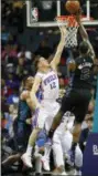  ?? NELL REDMOND — THE ASSOCIATED PRESS ?? Charlotte Hornets forward Marvin Williams, right, shoots over Philadelph­ia 76ers guard T.J. McConnell in the second half of Sunday’s game in Charlotte, N.C.