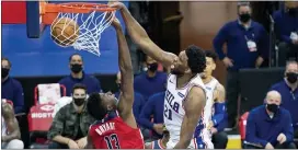  ?? CHRIS SZAGOLA — THE ASSOCIATED PRESS ?? Joel Embiid, right, dunks on Washington’s Thomas Bryant, left, during the first half on Wednesday at the Wells Fargo Center.