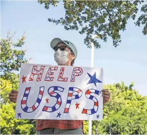  ?? BRONTE WITTPENN/ USA TODAY NETWORK ?? Sarah Lyford expresses her support for the U. S. Postal Service during a rally Tuesday in front of a post office in Austin, Texas. Some fear postal cutbacks could interfere with elections.