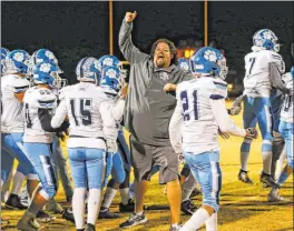  ?? Chase Stevens Las Vegas Review-journal @csstevensp­hoto ?? Centennial coach Dustin Forshee celebrates with his team after their win in the Class 4A semifinals in 2019. Centennial won the state championsh­ip and that was the last normal circumstan­ces high school football game played in Nevada.