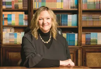  ?? GABRIEL MCCURDY/THE NEW YORK TIMES ?? Karen Kingsbury sits March 15 in Tennessee with copies of her books behind her.
