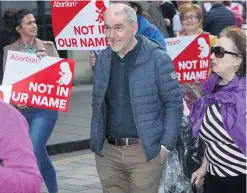  ??  ?? Tyrone GAA manager Mickey Harte at the March For Their Lives rally in Belfast and (right) the Rally for Choice parade in Belfast