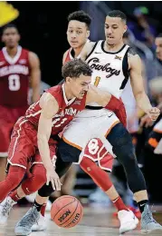  ?? [AP PHOTO] ?? Oklahoma’s Trae Young, left, tries to work his way around Oklahoma State’s Kendall Smith during the Big 12 Tournament on Wednesday in Kansas City, Mo. OU and OSU will find out their NCAA fates on Sunday.