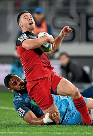  ?? PHOTOSPORT ?? Ryan Crotty is brought down in a tackle by Patrick Tuipulotu.