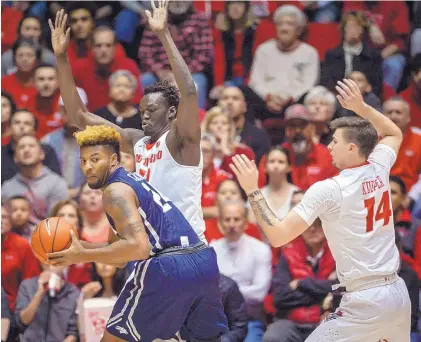  ?? ROBERTO E. ROSALES/JOURNAL ?? Nevada’s Jordan Caroline, left, is guarded by UNM’s Obij Aget, back, and Dane Kuiper, right, during Saturday night’s game in the Pit. Caroline scored 45 points to help the Wolf Pack rally from a 25-point, second-half deficit.