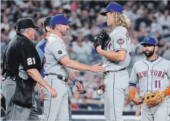  ?? ASSOCIATED PRESS FILE PHOTO ?? New York Mets manager Mickey Callaway, second from left, talks to starting pitcher Noah Syndergaar­d during the sixth inning of the team's interleagu­e baseball game against the Yankees last Friday in New York.