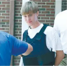  ?? (AP FOTO) ?? ‘MASS MURDERER.’ In this June 18, 2016 file photo, Dylann Storm Roof is escorted from the Sheby Police Department in Shelby, N.C. The trial for Roof, a white man accused of killing nine black people at the church, started on Dec. 7, 2016, at the...