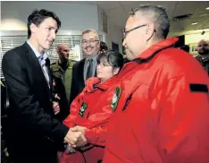  ?? SEAN KILPATRICK/THE CANADIAN PRESS ?? Arctic Rangers Priscilla Canadien, middle, and husband Joseph Canadien, right, of Fort Providence, N.W.T., greet Prime Minister Justin Trudeau as he takes part in a meet and greet with members of the Canadian Forces in Yellowknif­e, Northwest...