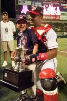  ?? BETH A. KEISER — THE ASSOCIATED PRESS FILE ?? The Indians’ Sandy Alomar shows off his MVP trophy with his son, Marcus, after the 1997 All-Star game in Cleveland.