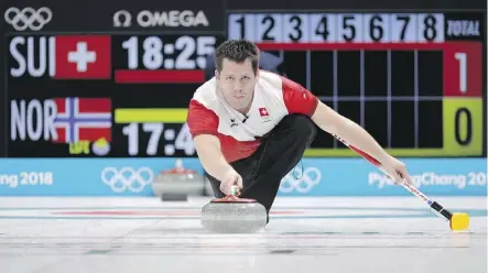  ?? AARON FAVILA/THE ASSOCIATED PRESS ?? Swiss curler Martin Rios prepares to throw a stone in Switzerlan­d’s match against Norway. Beating the Swiss was no small accomplish­ment for Canada; they are one of the more formidable opponents in the field and Switzerlan­d has won six of the 10 world...