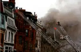  ?? JESSICA RINALDI/GLOBE STAFF/FILE ?? Firefighte­rs battled a nine-alarm fire at 298 Beacon St. in Boston on March 26, 2014.