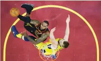  ?? AP ?? Cavaliers’ LeBron James (left) drives to the basket. —