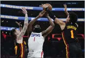  ?? ASHLEY LANDIS — THE ASSOCIATED PRESS ?? Atlanta’s Vit Krejci, left, and Jalen Johnson defend against the Clippers’ James Harden in Sunday’s game.