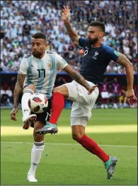  ?? AP/THANASSIS STAVRAKIS ?? France’s Olivier Giroud (right) battles for a ball with Argentina’s Nicolas Otamendi during Saturday’s match at Kazan, Russia.