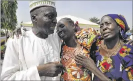  ?? OLAMIKAN GBEMIGA / AP ?? Family members celebrate as they embrace a relative, one of the released kidnapped schoolgirl­s, in Abuja, Nigeria, on Saturday. Eighty-two Nigerian schoolgirl­s were released after more than three years in Boko Haram captivity.