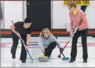  ?? NEWS PHOTO RYAN MCCRACKEN ?? Skip Holly Stroh lets go of her shot while teammates Lory dela Cruz (left) and Joanne Hodges prepare to sweep during the eighth end of Sunday’s Ladies Bonspiel A event final at the Medicine Hat Curling Club.