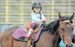  ?? DESIREE ANSTEY/ JOURNAL PIONEER ?? Jaylynn Perry, 3, from Abram-Village rides a pony called “Slice” at the agricultur­al festival.