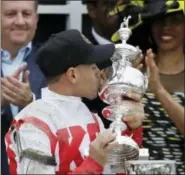  ?? MATT SLOCUM — THE ASSOCIATED PRESS ?? Javier Castellano, the jockey for Cloud Computing, celebrates with the Woodlawn Vase after Saturday’s win.