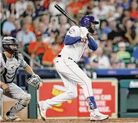  ?? Tim Warner/Getty Images ?? Yordan Alvarez strokes a run-scoring single in the eighth inning Saturday, one of his two hits that may have been aided by the lack of a defensive shift.