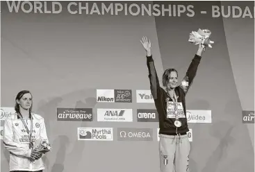  ?? Michael Sohn / Associated Press ?? For a change, Katie Ledecky, left, has to look up to someone on the podium as Italy’s Federica Pellegrini beat her in the 200-meter freestyle final. It was Ledecky’s first individual silver at the world championsh­ips or Olympics.