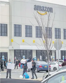  ?? Bebeto Matthews, The Associated Press ?? Workers at Amazon's fulfillmen­t center in the Staten Island borough of New York protest work conditions in the company's warehouse on March 30.