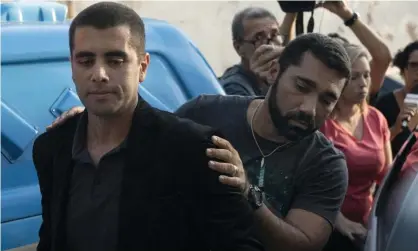  ?? Photograph: Leo Correa/AP ?? Denis Furtado is escorted by police after his arrest in Rio de Janeiro in July