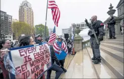  ?? Matthe6 dae smith / lansing state Journal 7ia ap ?? Protesters rtlly in april to denounce gov. gretchen 6hitmer's stty-home order tnd business restrictio­ns due to co7id-19, tt the sttte ctpitol in ltnsing, mich.