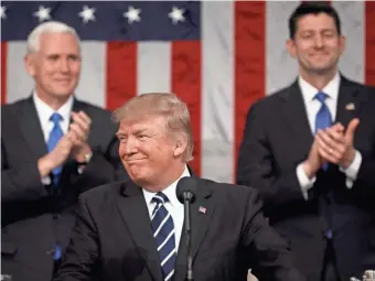  ?? GETTY IMAGES ?? Vice President Mike Pence (left) and House Speaker Paul Ryan applaud as President Trump addresses Congress.
