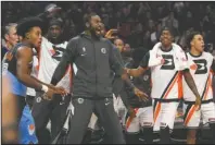  ?? The Associated Press ?? SIDELINE ENERGY: Members of the Los Angeles Clippers celebrate from the bench as Cleveland Cavaliers guard Collin Sexton, left, walks away during the second half of a Jan. 14 game in Los Angeles. At the NBA restart, where the only fans inside the building are the ones wearing uniforms, enthusiasm from players on the bench is most definitely getting noticed.