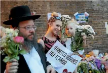  ?? PHOTO: GETTY IMAGES ?? A Jewish man joins a woman and her child at a vigil at the Finsbury Park mosque yesterday for the victims of the van attack.