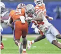  ?? KYLE ROBERTSON/COLUMBUS DISPATCH ?? Ohio State cornerback Shaun Wade (24) attempts to tackle Clemson’s Travis Etienne (9) in the Sugar Bowl on Jan. 1.
