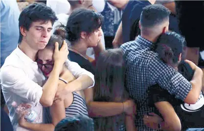  ?? (AP FOTO) ?? RELATIVES AND FRIENDS mourn during the state funeral service of some of the earthquake victims in Ascoli Piceno, Italy. Funerals for some victims took place on Friday, while those for many others are expected in the coming days.