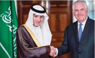  ??  ?? WASHINGTON: US Secretary of State Rex Tillerson shake hands with Saudi Foreign Minister Adel AlJubeir yesterday, shortly before their private meeting at the US Department of State.