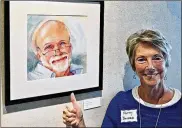  ??  ?? Watercolor artist Kathy Prosser Bovard stands alongside a portrait of her husband, Gary. The canvas was accepted into the Pennsylvan­ia Watercolor Society Exhibition.