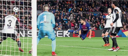  ?? Reuters ?? Crucial touch: Barcelona’s Luis Suarez (centre) heading in the goal against Valencia in the Spanish King’s Cup semi-final first -leg match at the Nou Camp on Thursday. —