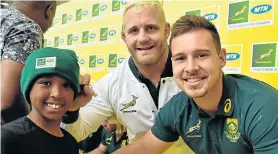  ?? Picture: EUGENE COETZEE ?? MAKING FRIENDS: Boks Vincent Koch, left, and Ivan van Zyl sign autographs for fan Dylan Baatjies, 10, of Arcadia before Saturday’s Test against Australia