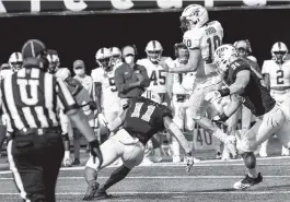  ?? DANIEL A. VARELA dvarela@miamiheral­d.com ?? Middle Tennessee quarterbac­k Asher O’Hara leaps in the air as he is being tackled by FIU defenders during the first half at Riccardo Silva Stadium on Saturday.