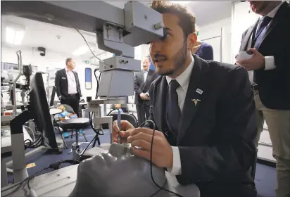  ?? PHOTOS BY KARL MONDON— STAFF PHOTOGRAPH­ER ?? Andreas Di Luciano, an ophthalmol­ogist for the Orbis team, demonstrat­es a surgery simulator during a stop Sunday at Moffett Field.